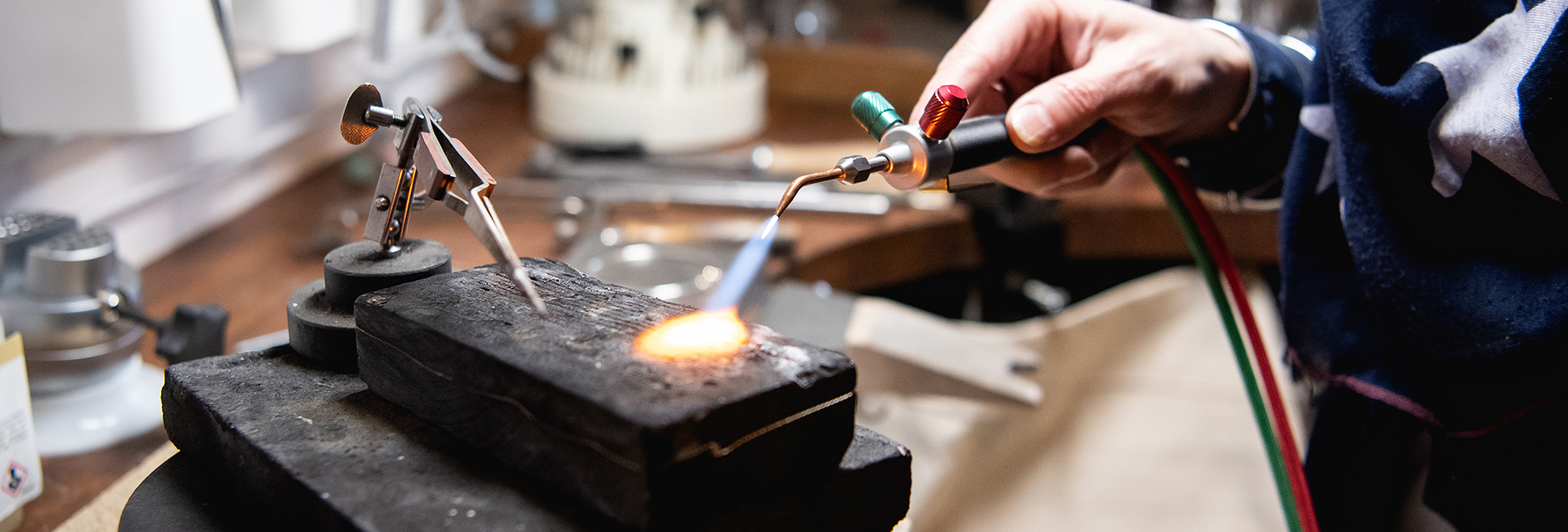 Jeweller working with a bench torch