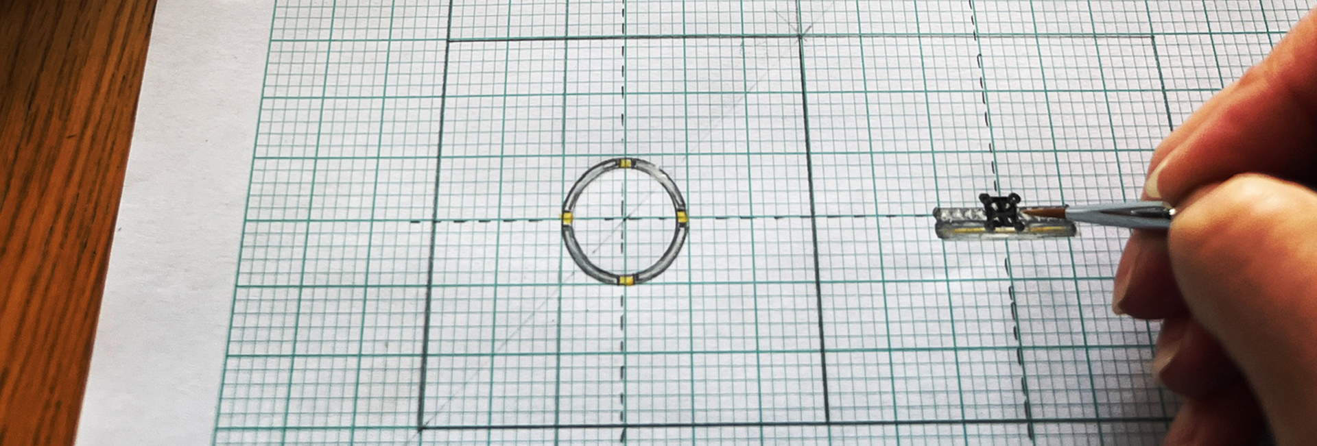 Hand-drawn ring design on graph paper